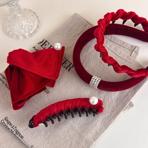 Elegant festive red velvet headband set with white pearl accents on vintage linen background