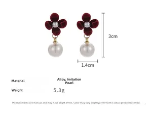Detail view of red velvet flower earrings with size measurements and pearl accents