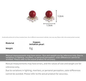 Detailed macro view of vintage red bean earrings with faux pearls and copper base