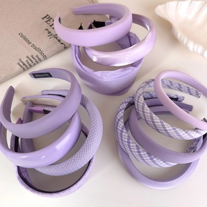 Elegant lavender headbands in various textures on a white tray with aesthetic styling