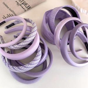 Collection of elegant lavender wide headbands in various textures on a clean white backdrop
