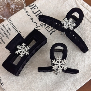 Elegant black velvet hair claws with silver rhinestone snowflakes for winter hairstyles