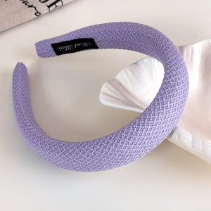 Detailed weave texture of lavender blue padded headband with Hand Made label