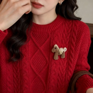 Cute brown plush horse brooch pinned on a cozy red cable knit sweater for women