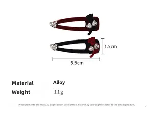 Detail view of 5.5cm velvet heart hair clips in burgundy and black with rhinestone bow