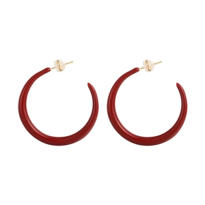 Red enamel C-shaped hoop earrings with gold metal posts on a clean white background