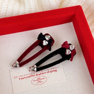 Detail view of vintage velvet heart hairpins with rhinestones and floral fabric accents