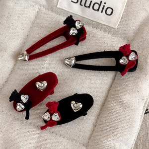 Detail of vintage velvet hair clips with heart metal decor and sparkling rhinestones