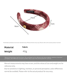 Detailed view of red and white plaid fabric headband with size specs and gold button