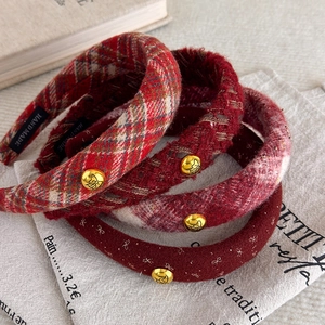 Retro red plaid plush headbands with gold metallic accents and handmade woven labels