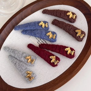 Set of four vintage knit hair clips in neutral colors with golden horse ornaments