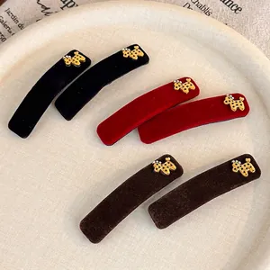 Red and black velvet hair clips with golden dog charms and sparkling rhinestones