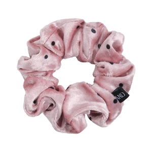 Close-up of pink velvet scrunchie with black polka dots and high-quality plush texture