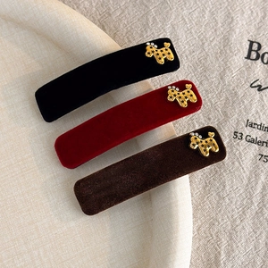 Three-piece velvet hair clip set in red, black, and brown with golden dog charms