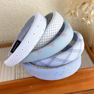Blue floral and plaid padded headbands set in a rustic wooden tray decoration