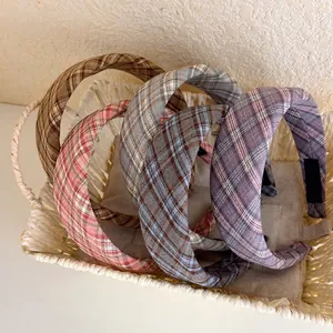 Classic plaid wide headband in various colors showcased in a woven basket display