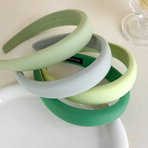 Green padded sponge headbands in various shades with a premium handmade label finish