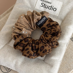 Leopard print scrunchie with silver stars and fashion label for high ponytail styles