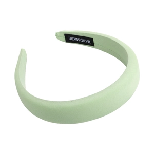 Minimalist light green padded sponge headband for women with a handmade woven label