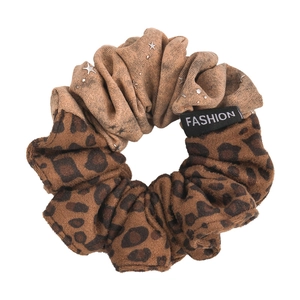 Chic leopard print and star pattern hair scrunchie with fashion label for elegant styling
