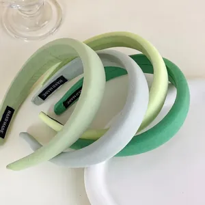 Set of four thick padded sponge headbands in gradient green shades with handmade labels