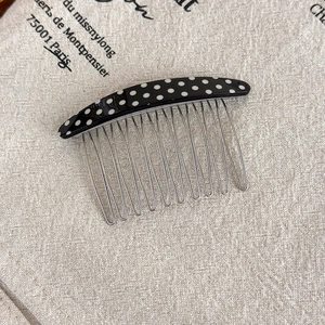 Close-up of retro polka dot acetate hair comb with twelve durable metal teeth