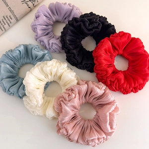 Set of six glossy satin scrunchies in vibrant colors like purple, red, and blue