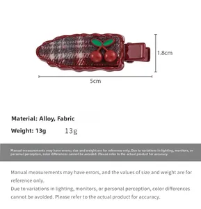 Detailed view of carrot-shaped hair clip with red cherry accents and size specifications