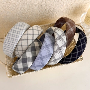 Classic plaid fabric headbands in various colors displayed in a woven basket