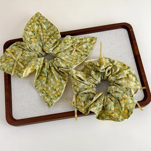 Französisches Vintage Haargummi Set mit Blumenmuster und gelben Bändern auf Grün