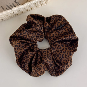 Detailed view of leopard print velvet scrunchie showing soft texture and high elasticity
