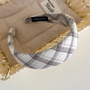 Detailed shot of handmade plaid fabric headband with a vintage black and white check pattern