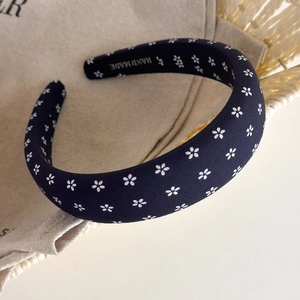 Detailed macro view of the navy blue floral headband fabric and handmade inner lining