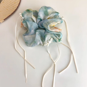 Detail of blue Monet style scrunchie with soft ink floral print and white faux pearls