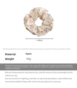 Detailed view of floral fabric scrunchie with red flowers on cream base and dimensions