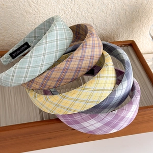 Vintage cream plaid sponge headbands in five colors on a wooden glass tray