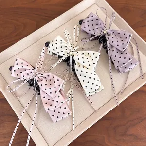 Set of three satin polka dot bow banana clips with crystals in pink, cream and lilac