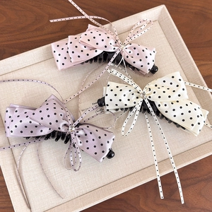 Elegant satin bow banana clips with polka dots in pink, cream, and lavender tones