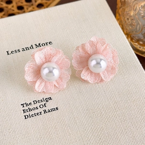 Macro detail of soft pink chiffon flower earrings with a delicate center pearl accent