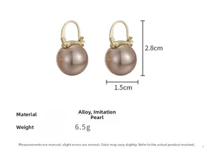 Detail view of champagne faux pearl drop earrings with dimensions 2.8cm by 1.5cm