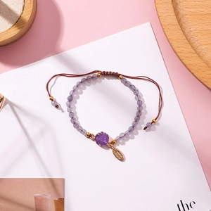 Adjustable woven bracelet with purple druzy crystal pendant and gold-plated bead accents