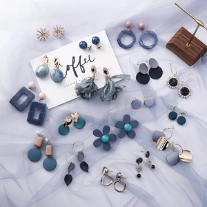 Collection of blue and grey geometric drop earrings with fabric tassels and floral designs