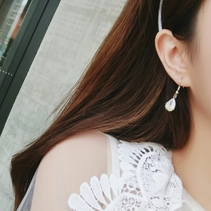Elegant water drop zircon earrings with gold hooks worn by a model in lace attire