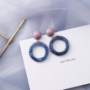 Detail of blue-grey marble acetate hoop earrings with morandi purple resin stud details