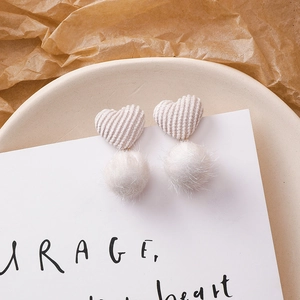 Détails de boucles d'oreilles en forme de cœur beige avec pompons en peluche blanche