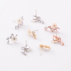Close-up of S925 shell flower earrings with zircon accents in gold and silver plating