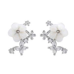 Macro detail of shell flower earrings with shimmering teardrop cubic zirconia stones