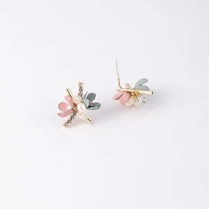 Macro detail of floral stud earrings with pink petals, crystals, and small white pearls