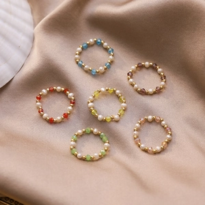Handmade beaded ring set with freshwater pearls and colorful crystals on silk