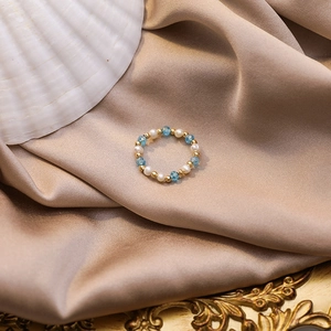 Summer handmade beaded ring with freshwater pearls and light blue faceted crystals on satin